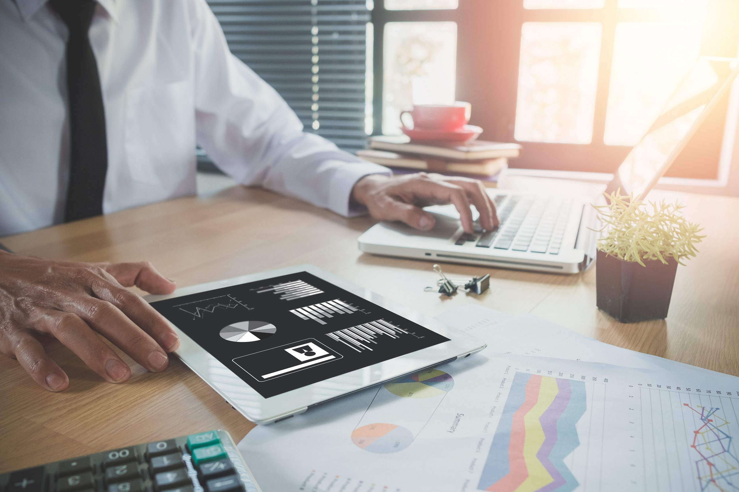 Businessman working with digital tablet and book and document on